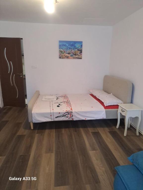 a small bedroom with a bed and a table at Strada Banu Mihalcea Nr. 150 in Constanţa