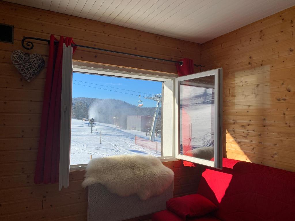 a room with a window with a view of the snow at Chalet Les Jouves in Prémanon