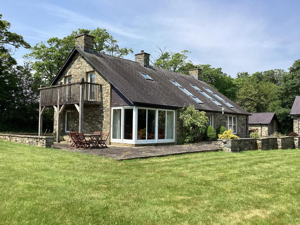an old stone house with a large yard at Bryn Isaf in Ystrad Meurig