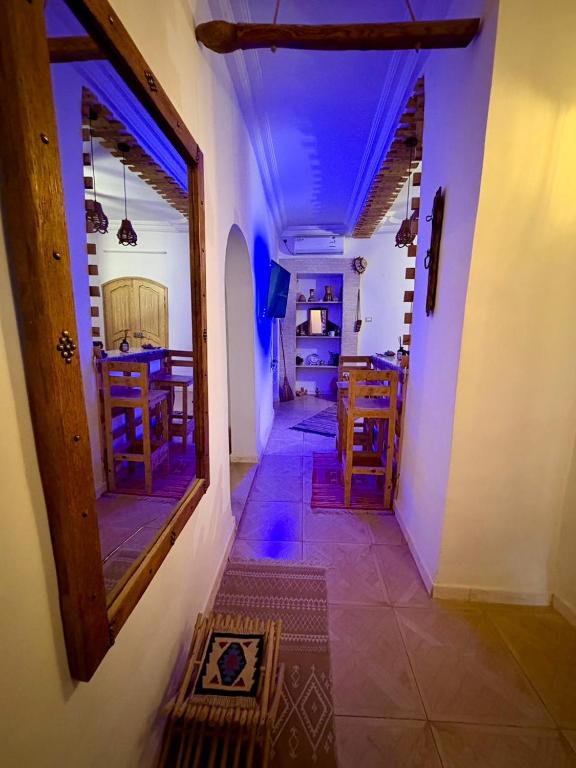 a hallway of a house with a table and chairs at Dar Chahla in Tozeur