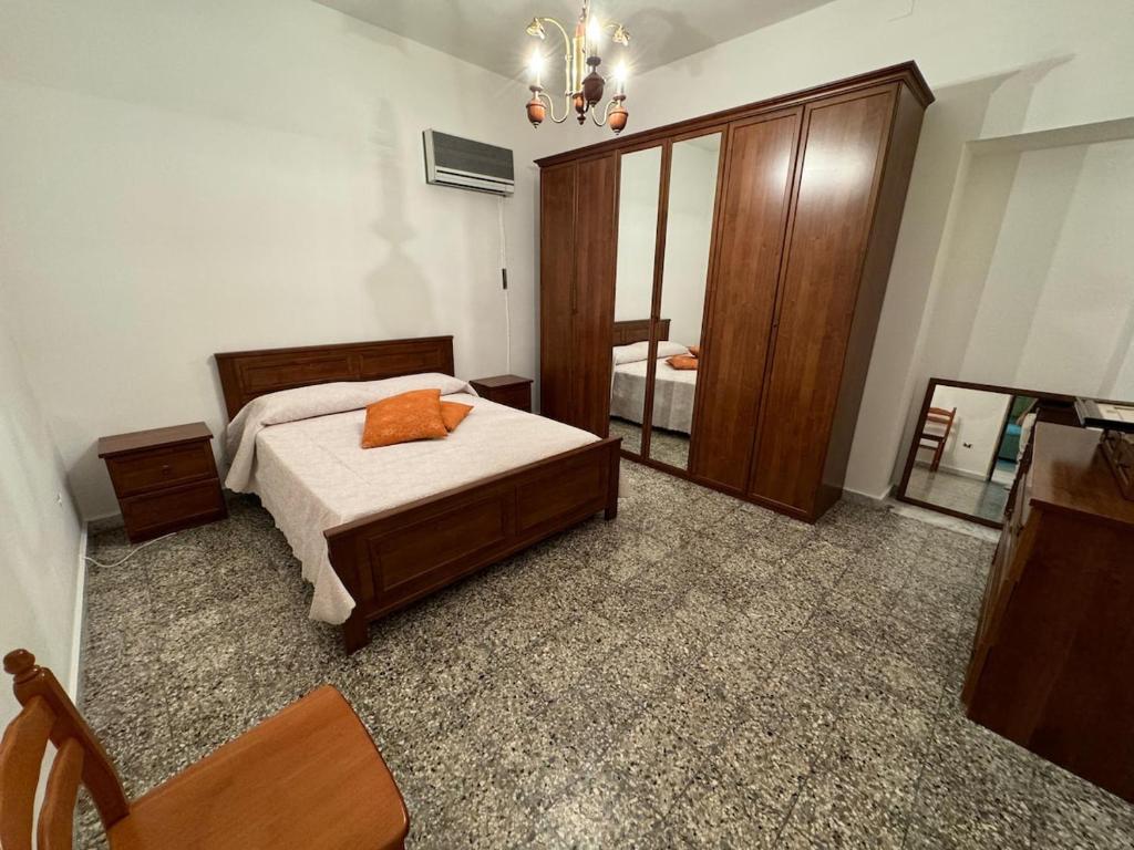 a bedroom with a bed and a large mirror at Casa della nonna in Donisi