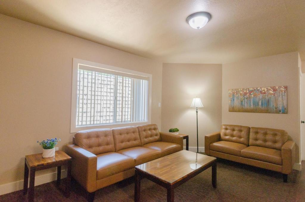 a living room with a couch and a table at Updated condo in Logan in Logan