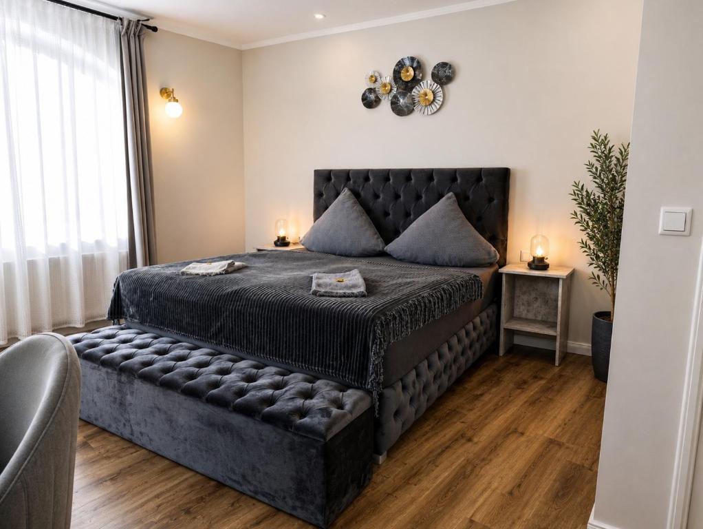 a bedroom with a large bed with a leather couch at Boutique Hotel in Bad Salzuflen