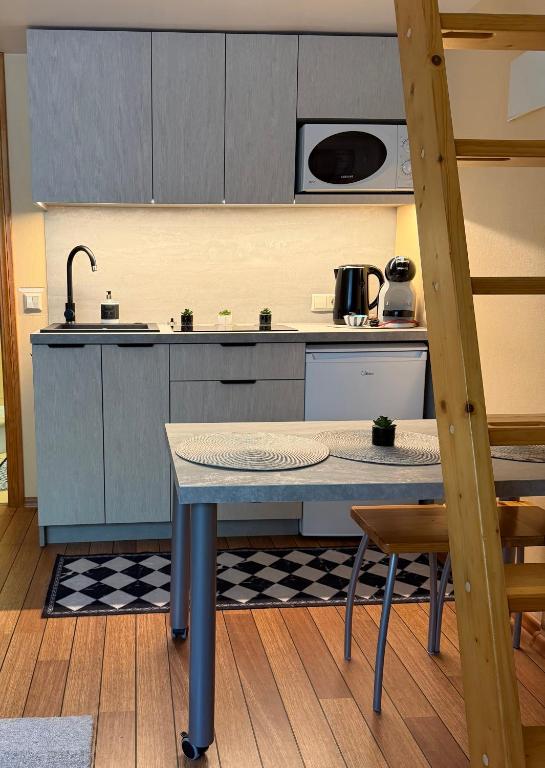 a kitchen with a table and a counter top at Pas Jūrate Villa Hubertus in Juodkrantė