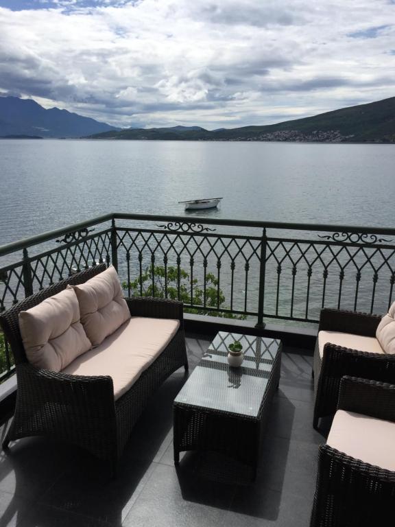 a balcony with couches and a view of the water at Apartments Seaside Baosici in Herceg-Novi