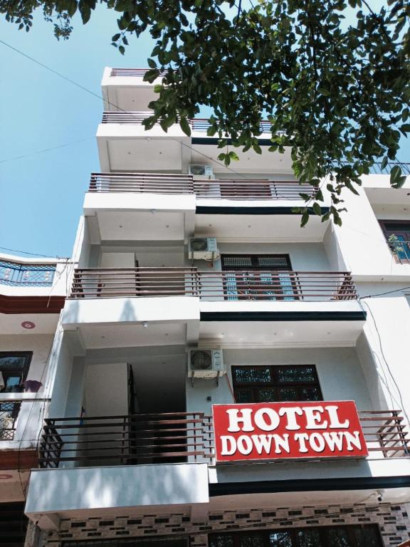 a hotel down town sign on the side of a building at Hotel Downtown in Kānpur