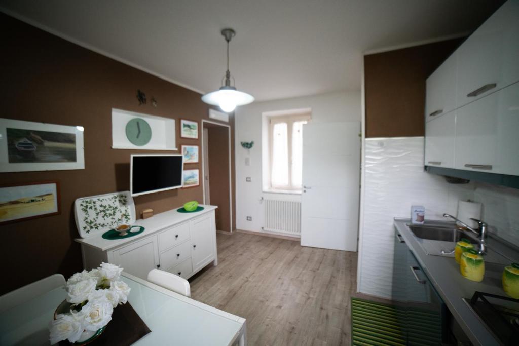 a kitchen with a sink and a desk in it at Casa Rosella in Sapri