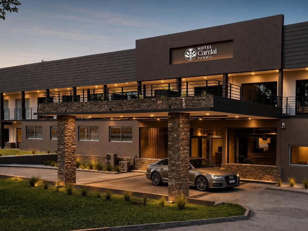 a car parked in a parking lot in front of a building at Hotel Cardal Tandil in Tandil