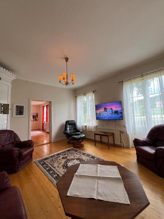 a living room with a couch and a table at Anders-Pers, The apartment downstairs in Järvsö
