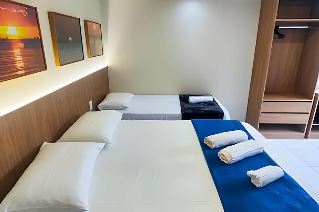 a room with three beds in a room at Refúgio da Praça: Charme e Conforto in Belém