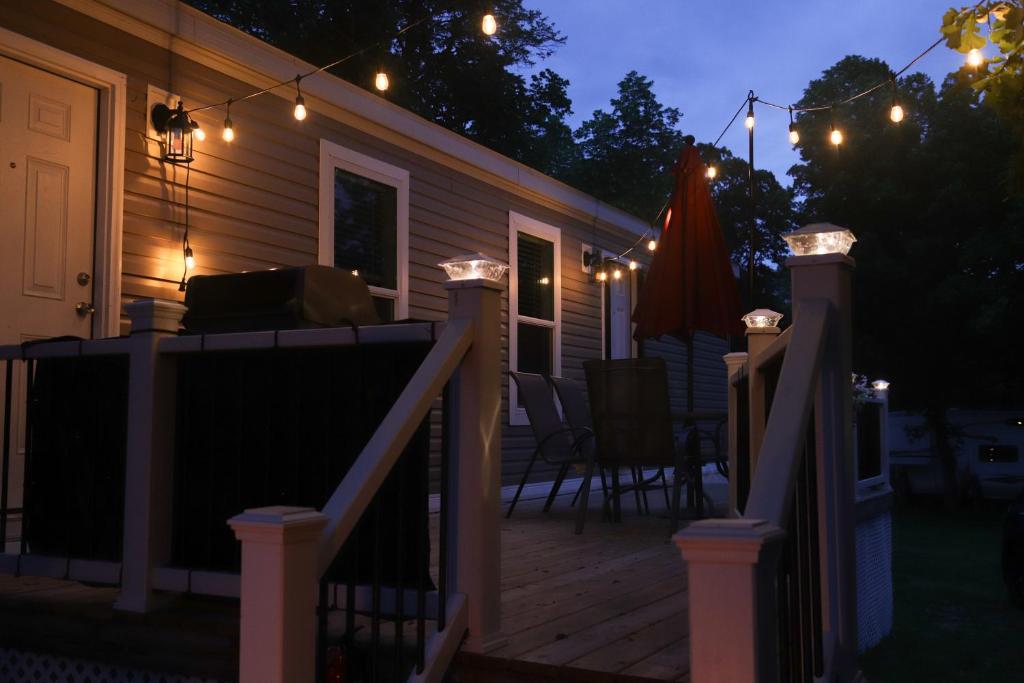 a house with a deck at night with lights at West Battle Lake w Lake Views in Battle Lake
