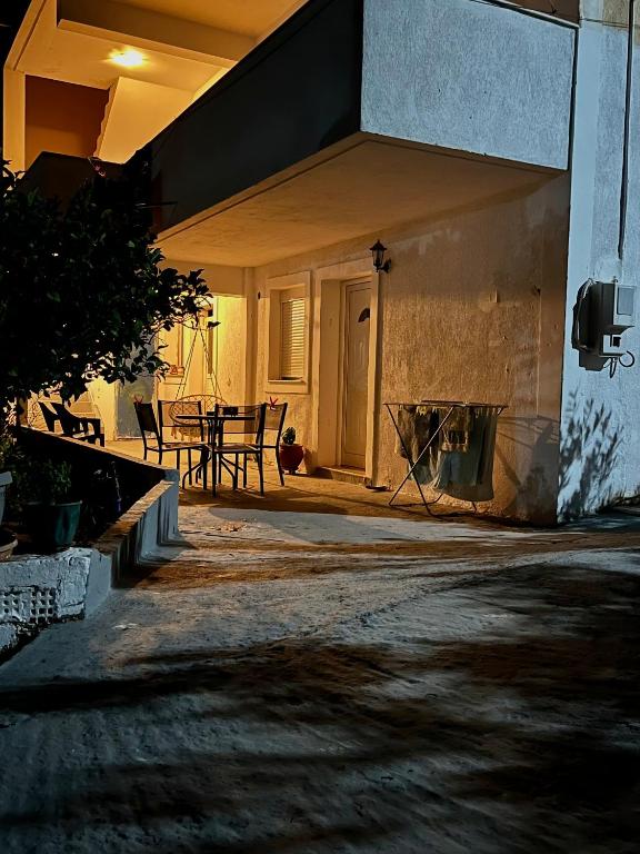 an outside view of a house with a table at Vouzianas home in Kefallonia