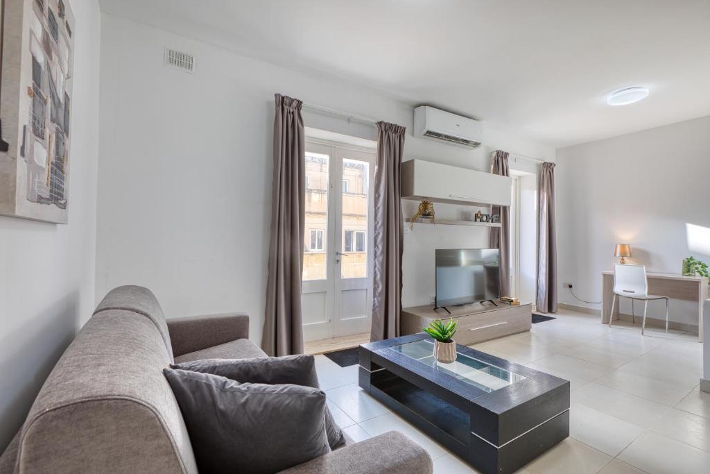 a living room with a couch and a coffee table at NEW - 2BR Beach side apt by SF HOMES in Sliema