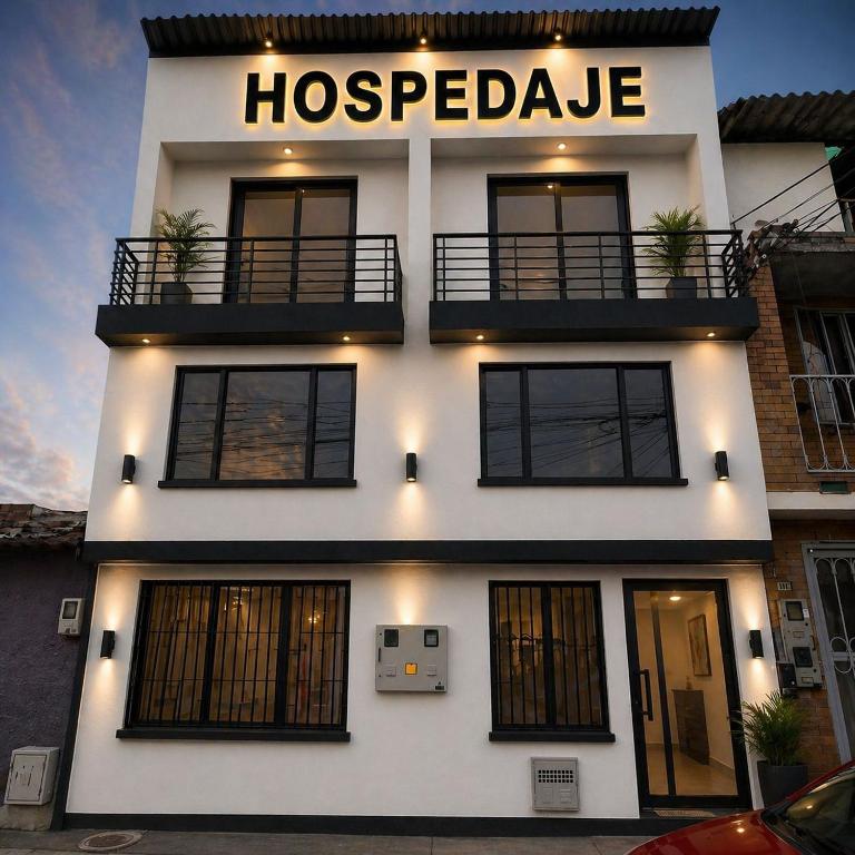 a large white building with a hospectedale sign on it at Hospedaje ZIG ZAG 2 in Tocancipá