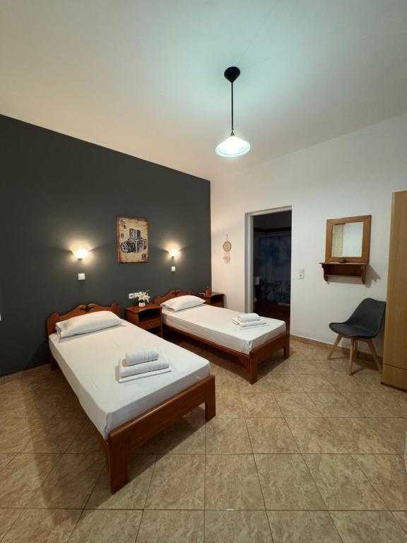 a room with two beds and a table and a chair at Dream catcher 1 in Agia Theodoti