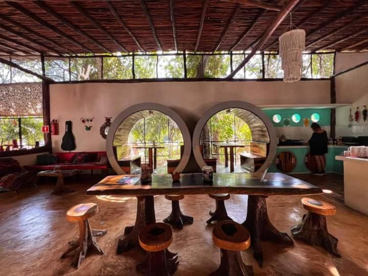 a large room with a table and some chairs at Hostal Mulut Tulum in Tulum