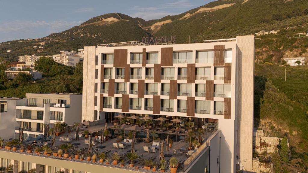 an aerial view of a hotel with a mountain at Magnus Hotel & SPA in Vlorë