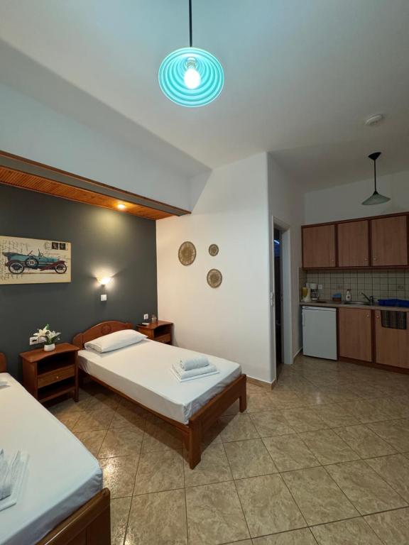 a large bedroom with a bed and a kitchen at Dream catcher 4 in Ios Chora