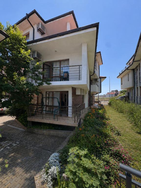 a house with a porch and a balcony at Villa Bella Sozopol in Sozopol