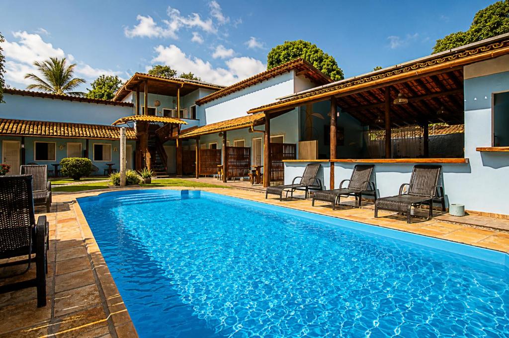 a swimming pool in the backyard of a house at Pousada Universo Arraial in Arraial d'Ajuda