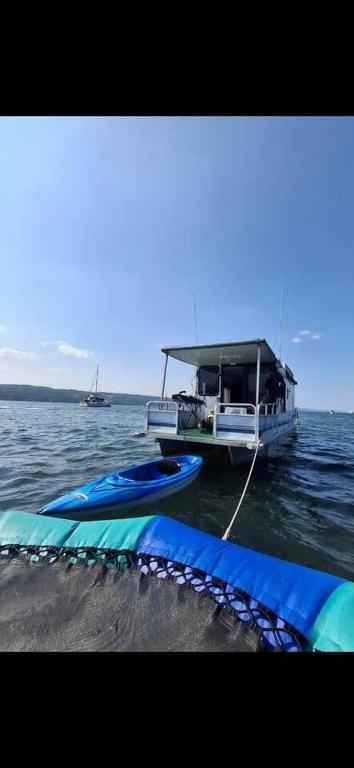 a boat is docked in the middle of the water at Knot Work Cayuga Lake 30ft Boat in Ithaca