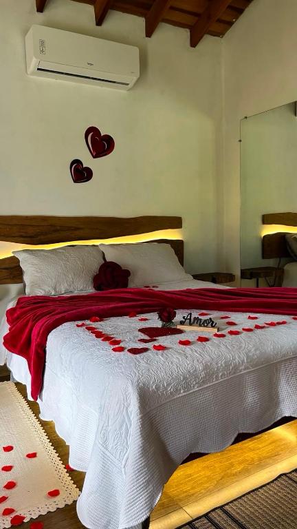 a bedroom with a bed with hearts on the wall at Villa Garibaldi in Joanópolis