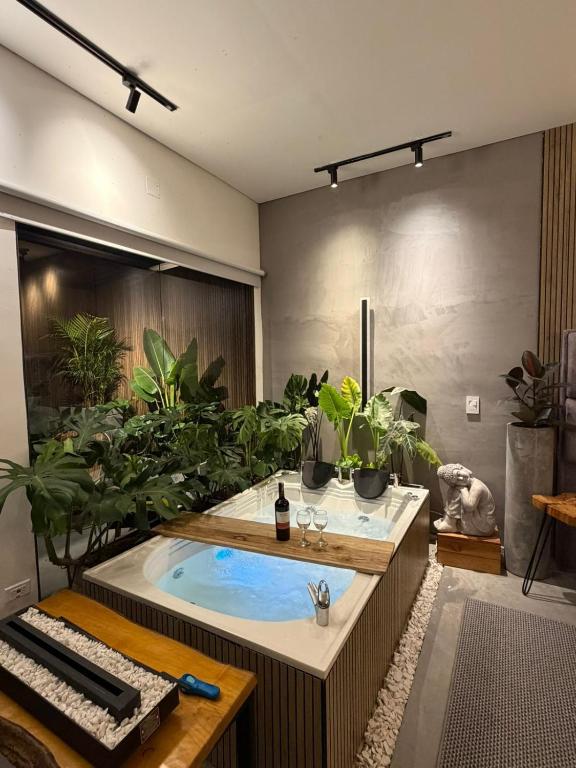 a hot tub in a room with potted plants at Animadbali1 in Ibagué