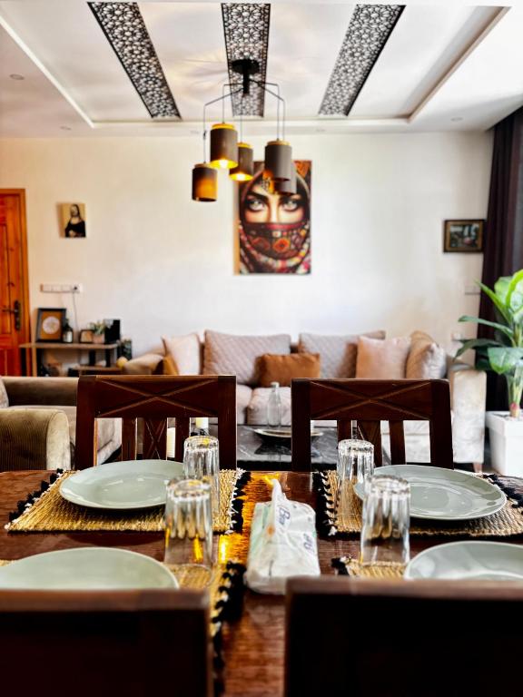 a dining room with a table and a couch at Garden view double room in Agadir