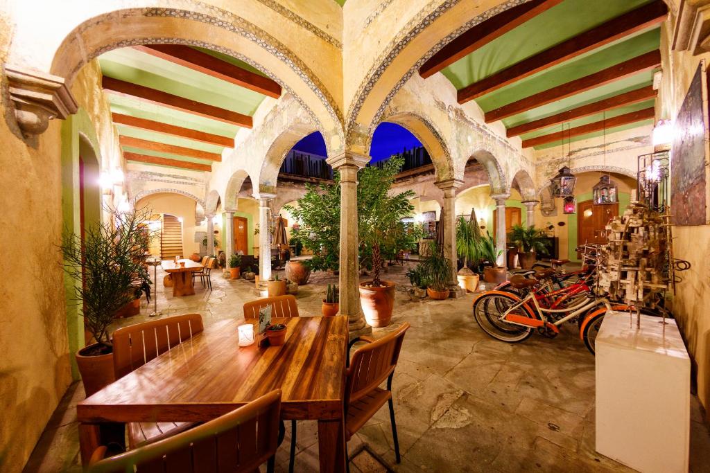 a restaurant with a wooden table and chairs and motorcycles at Casa De Sierra Azul in Oaxaca City