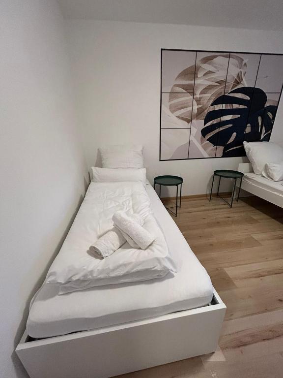 a white bed in a room with two pillows on it at Monteurs Freund in Lotte