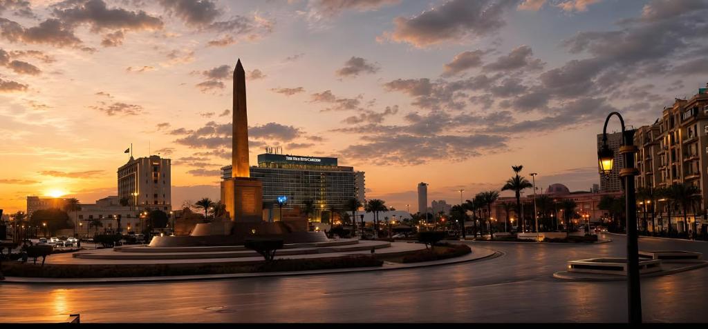 a city with a monument in the middle of a street at Lumina View Hotel by Tahrir - Downtown in Cairo