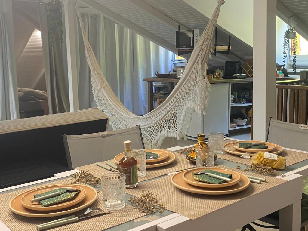 a dining table with plates of food on it at L'isménia, Le Loft in Le Gosier