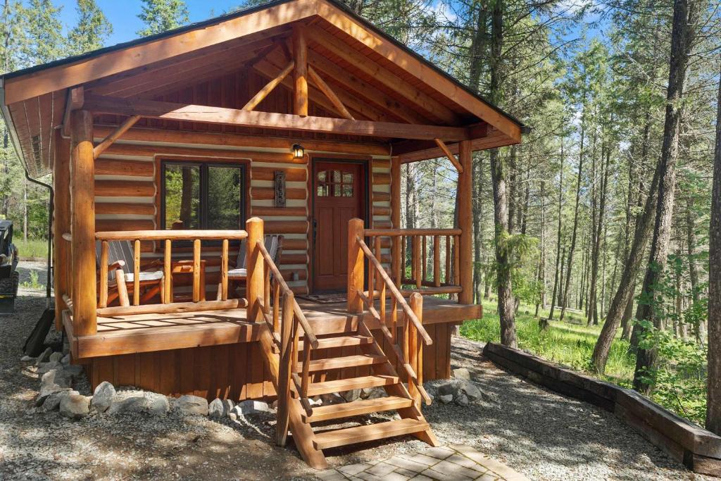 a wooden cabin in the woods with a stairway at Moose Hollow Studio Cabin in Eureka