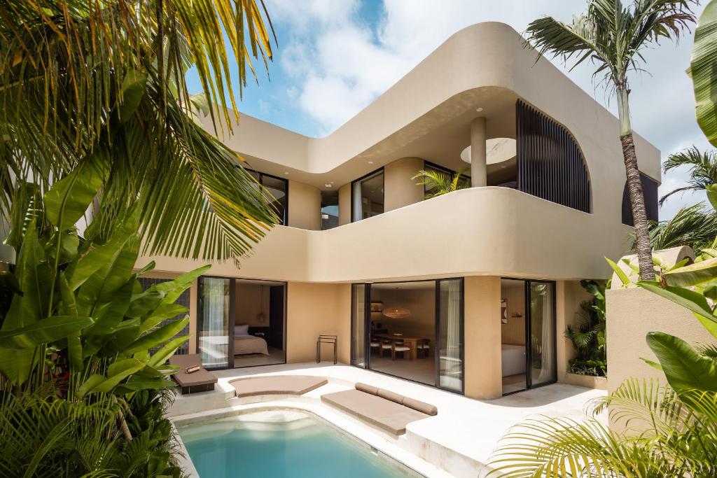 an exterior view of a house with a swimming pool at SISI Wellness Villas in Bingin Beach