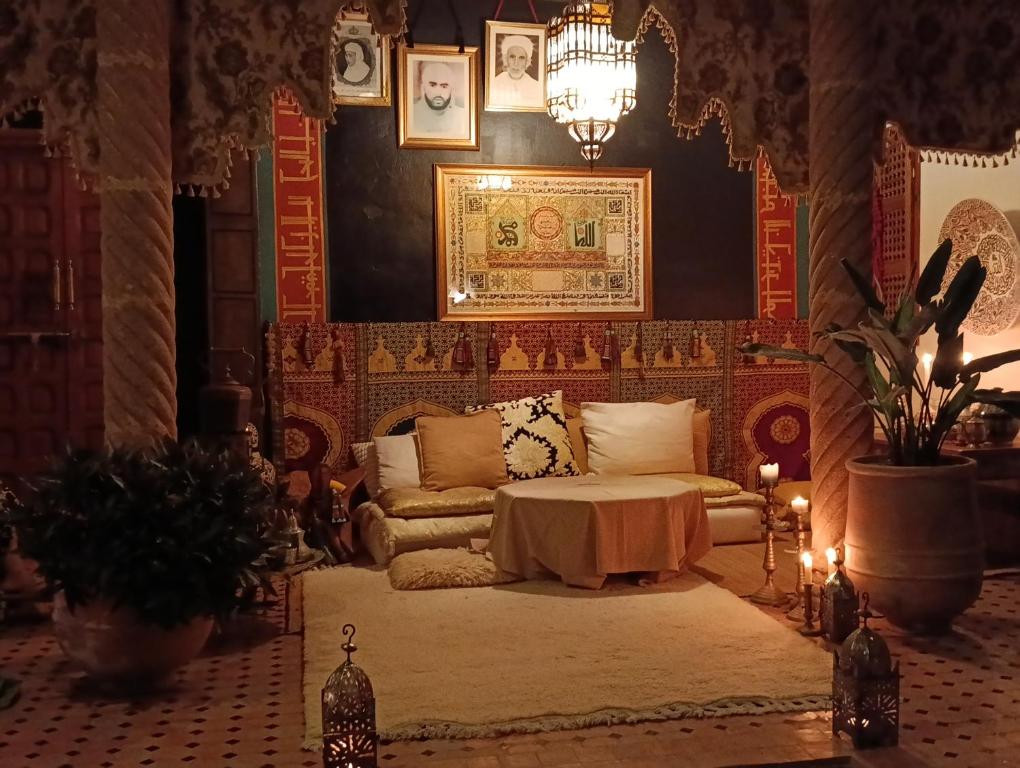a living room with a couch and a table at Riad Dar Badiaa in Salé