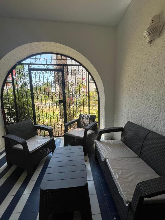 a living room with two couches and a window at Marina Escape, 2BD, Pool and Beach in Hammam Sousse