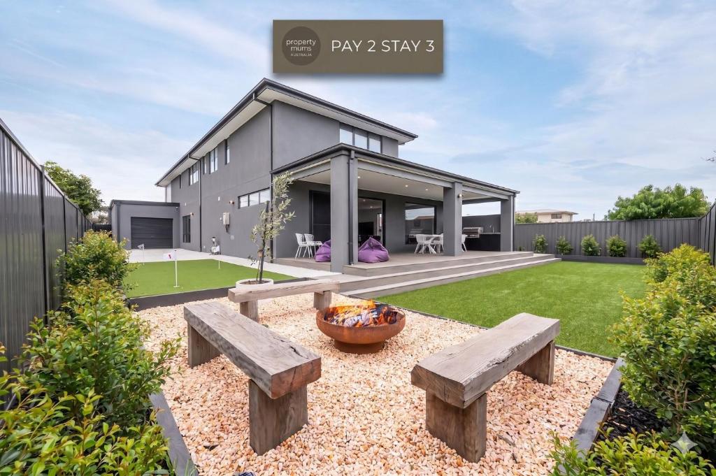 a house with a garden with benches in the yard at Rigby Retreat at St Leonards in Saint Leonards