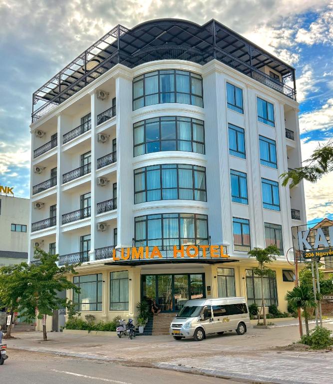 a hotel with a van parked in front of it at Lumia Hotel Vinh Yen in Vĩnh Phúc