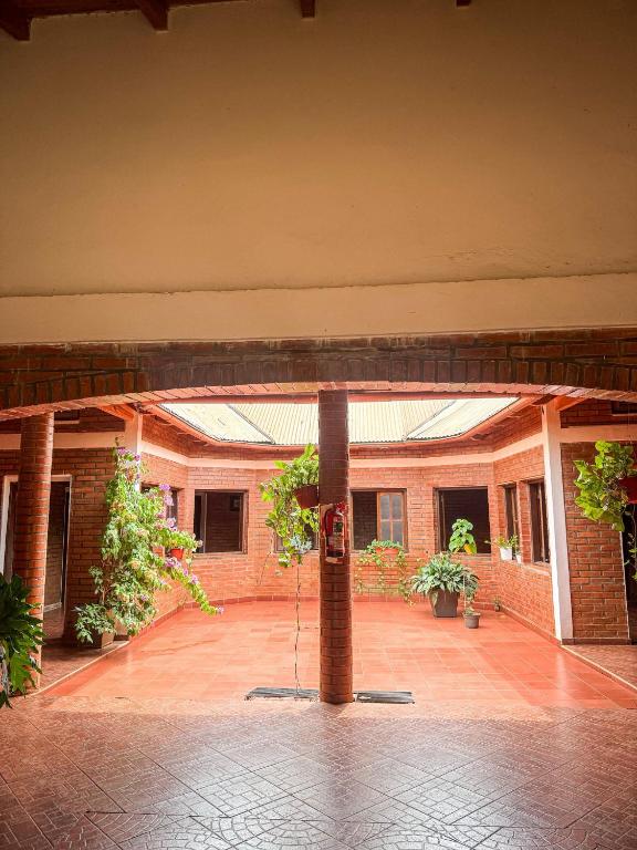 an empty courtyard of a brick building with plants at Madre America Hotel & Hostel in San Ignacio