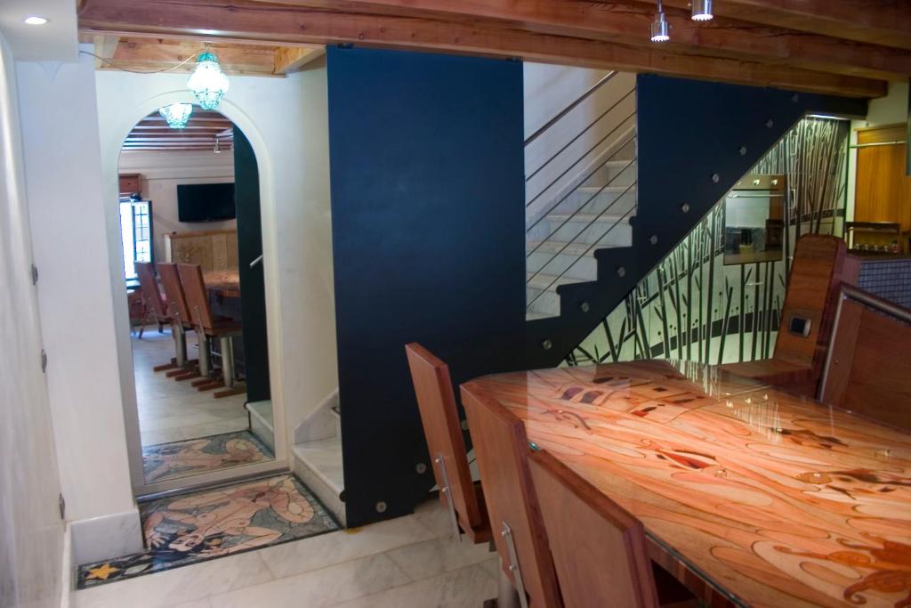 a dining room with a table and a staircase at Casa Carlo Goldoni by Sarlux in Venice