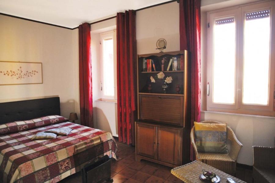 um quarto com uma cama, uma cadeira e janelas em Camera con Vista em Ancona