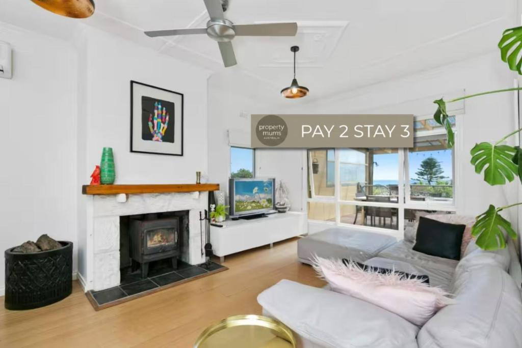 a living room with a couch and a fireplace at Nullegai Spa and Views in Dromana