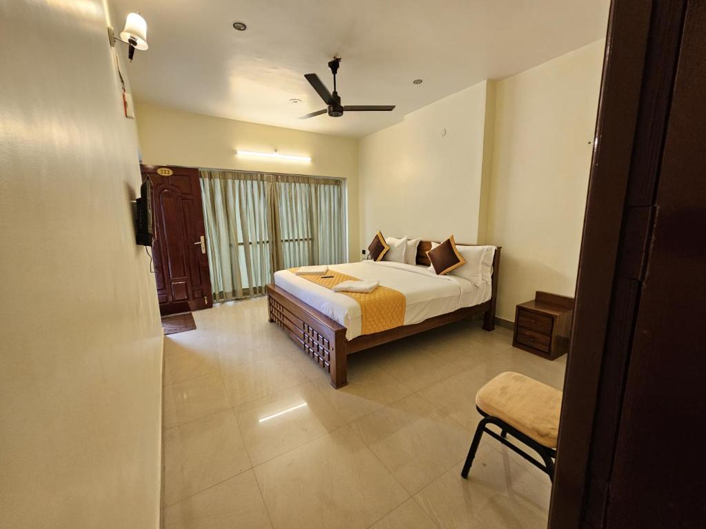 a hotel room with a bed and a window at SAAI Rosorts iin Yercaud in Yercaud