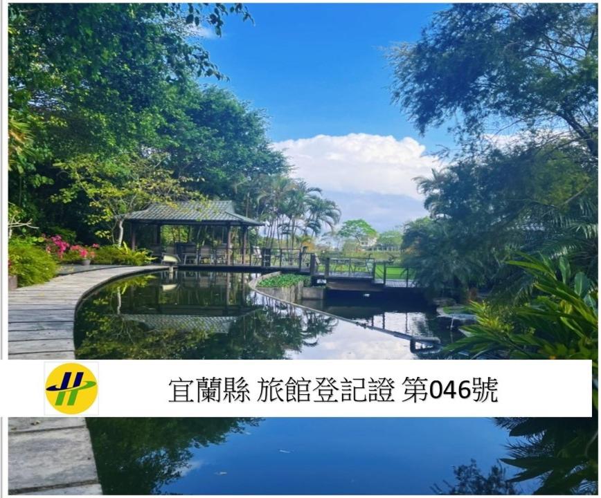 a bridge over a river in a park at Hofi Villa in Toucheng