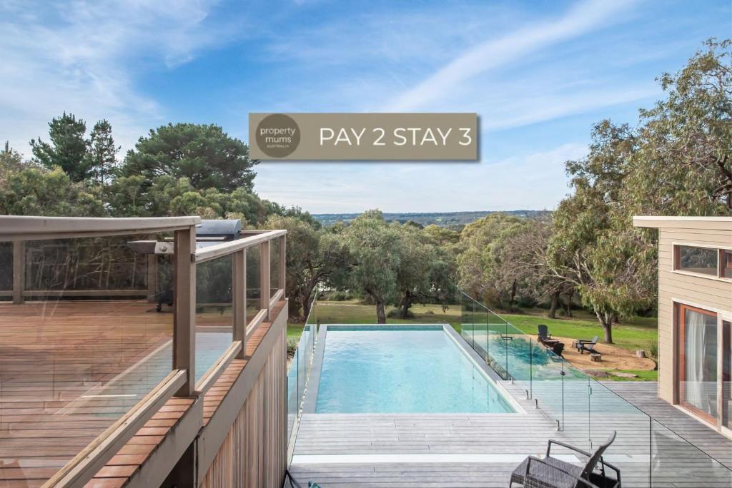 a house with a swimming pool and a deck at Long View - Heated Pool in Red Hill in Red Hill