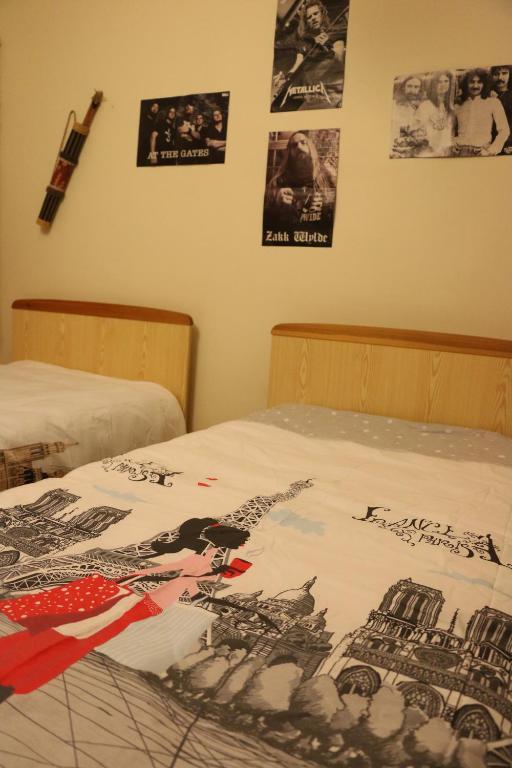 a bedroom with two beds with posters on the wall at Best Room in Town in Karakusunlar Köyü