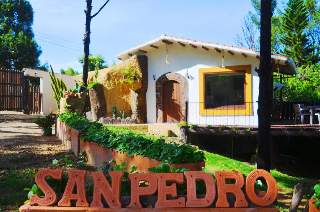 a small house with a sign in front of it at San Pedro in Ráquira
