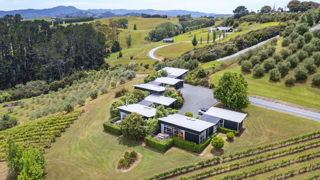 an aerial view of a farm with a group of buildings at Riverside Matakana in Matakana