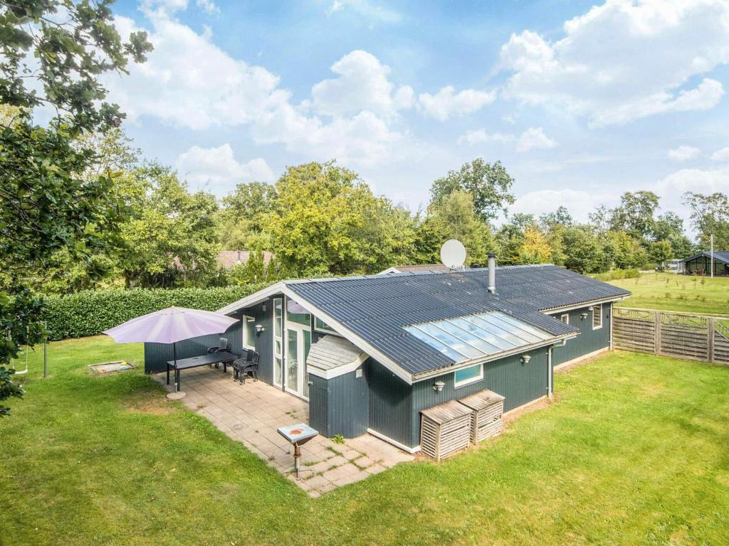 an overhead view of a green house with an umbrella at 8 person holiday home in Ørsted in Kare