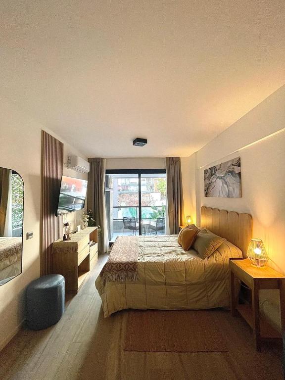 a bedroom with a large bed and a bathroom at Del Pino Park in Buenos Aires
